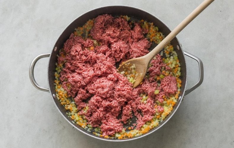 Lasagna with Meat Ragù and Savoy Cabbage, step 1: chopped carrot, onion and celery sautéed in butter with the ground meat