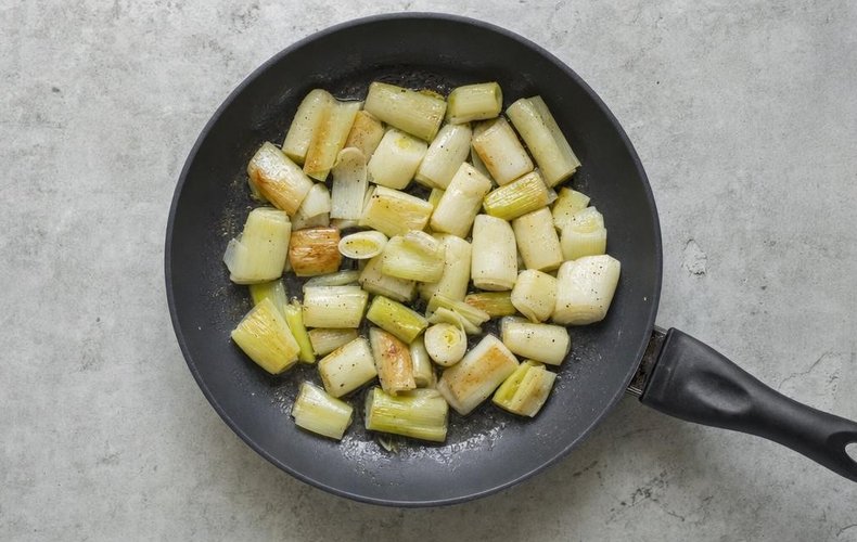 Leek Gratin, step 2: leek pieces cooking in butter in a nonstick skillet