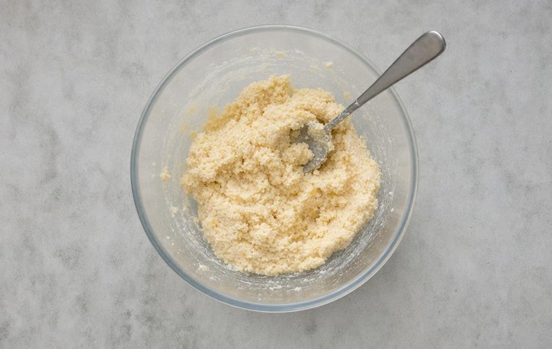 Lemon Coconut Truffles, step 3: the thick dough with powdered sugar, milk, limoncello and coconut flour