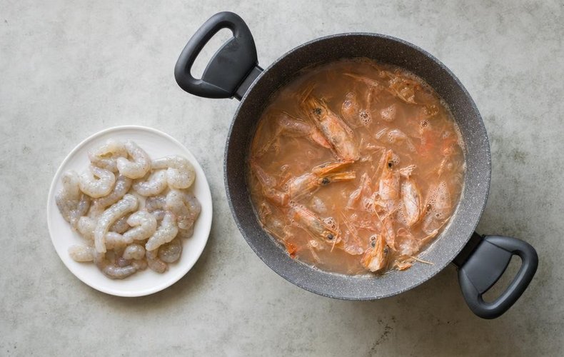 Licorice and Shrimp Risotto, step 1: shrimp heads and shells in a pan of water for the broth