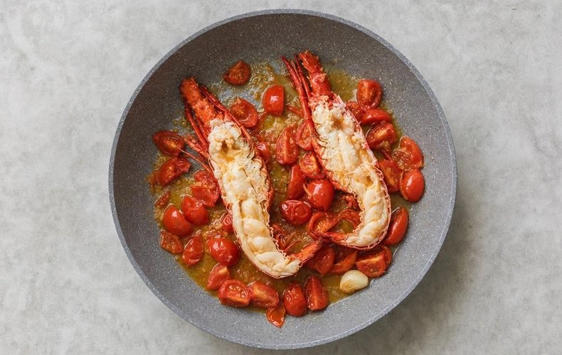 Linguine with lobster, step 2: lobster halves cooking with cherry tomatoes