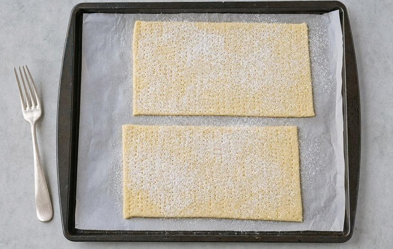 Millefeuille Cake with Torrone Cream, step 4: puff pastry rectangles pricked with a fork and dusted with powdered sugar