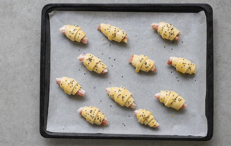 Crescents on a baking sheet lined with parchment paper