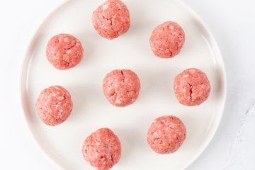 Seasoning the ground beef with salt, pepper and paprika