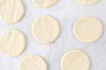 Cutting disks from the focaccia dough with a glass