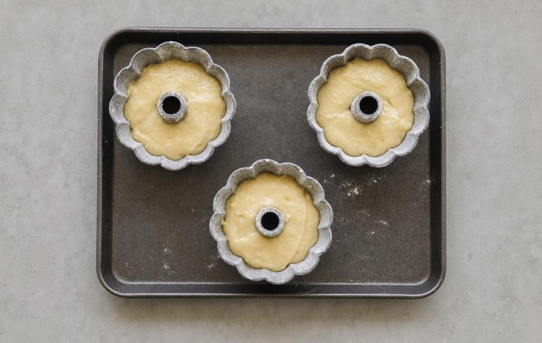 Mini Yogurt Bundt Cakes, step 3: buttered and floured molds filled with batter