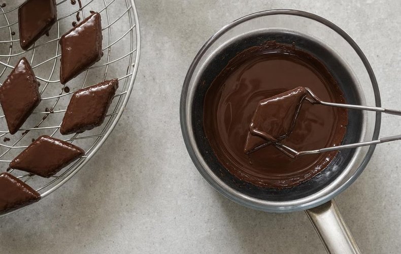Mostaccioli, step 4: dipping the cookies in melted dark chocolate
