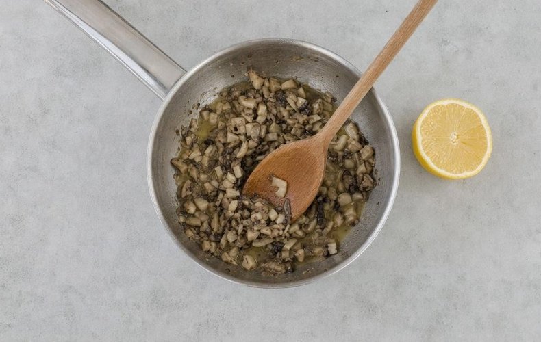 Mushroom Puff Pastry Rolls, step 2: mushrooms cooking with lemon and butter in a small saucepan