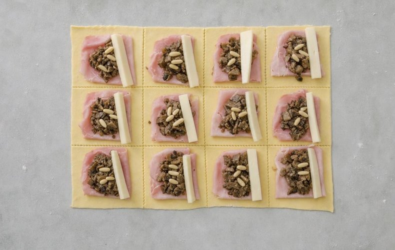Mushroom Puff Pastry Rolls, step 4: ham, mushrooms, pine nuts and fontina on the pastry rectangles