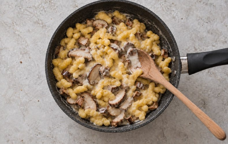 Mushroom spätzle, step 8: tossing the spätzle with mushrooms and cheese sauce