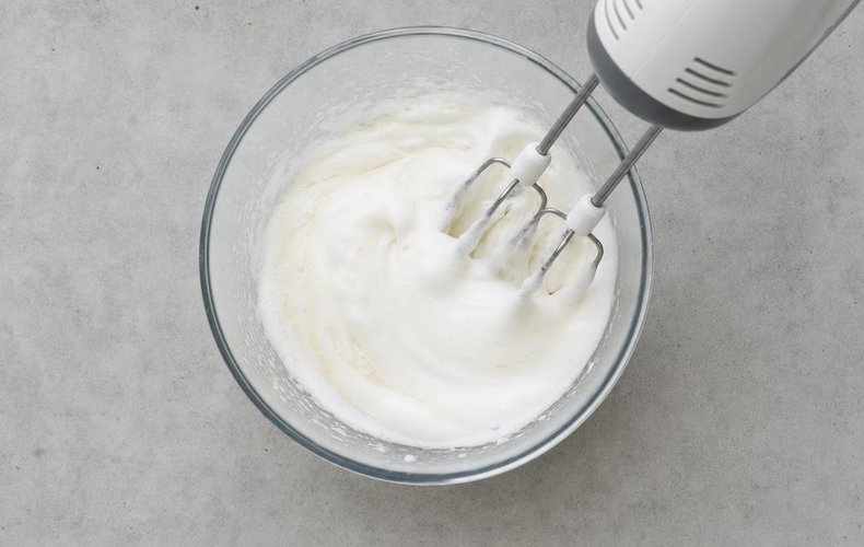Nougat Wafer Bites, step 3: whipped egg white beaten into the honey syrup