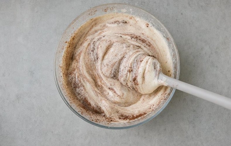 Folding the flour and cocoa into the egg mixture