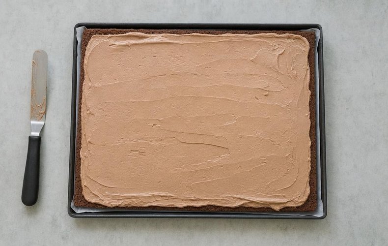 Spreading the Nutella cream over the cocoa sponge