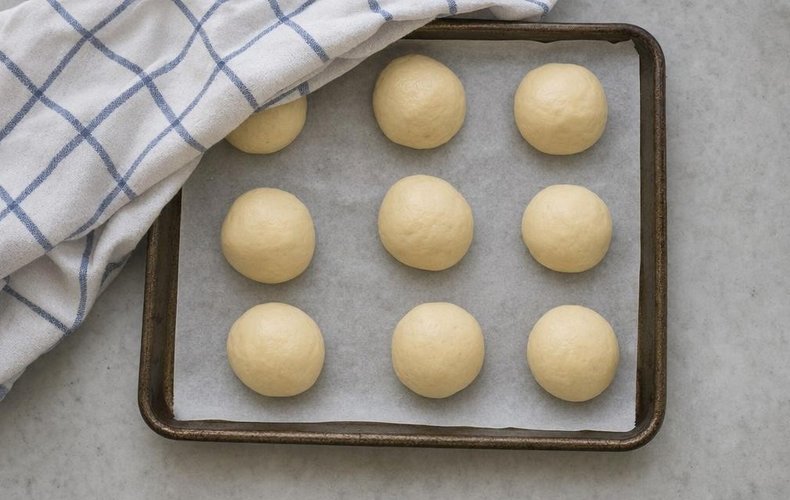 Original Swedish Semla, step 3: small buns on a baking sheet lined with parchment paper