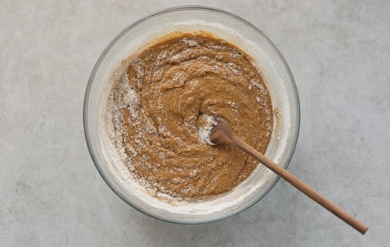 Pain d'Épices, step 2: flour, spices and the honey and milk mixture stirred with a wooden spoon