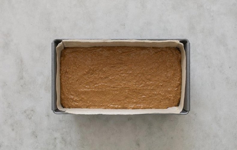 Pain d'Épices, step 4: the spice bread in a loaf pan lined with parchment paper