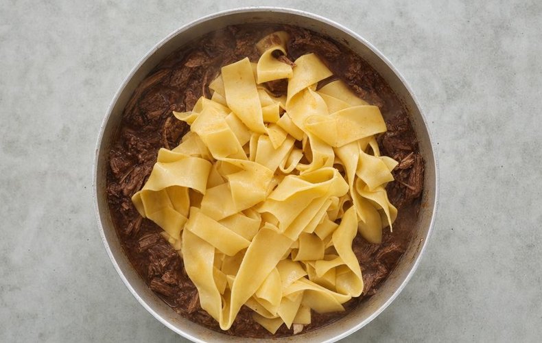 Pappardelle with Stracotto, step 2: pasta added to the skillet with the braised meat sauce