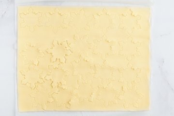 Brushing the snowflakes with egg yolk and milk