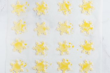 Sprinkling the snowflakes with Parmigiano Reggiano and paprika