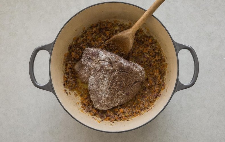 Pasta al Brasato, step 5: the floured beef browning in butter with the chopped vegetables