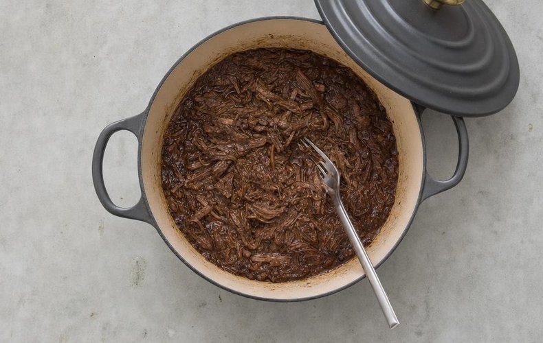 Pasta al Brasato, step 8: the braised beef broken into pieces with a fork in its sauce