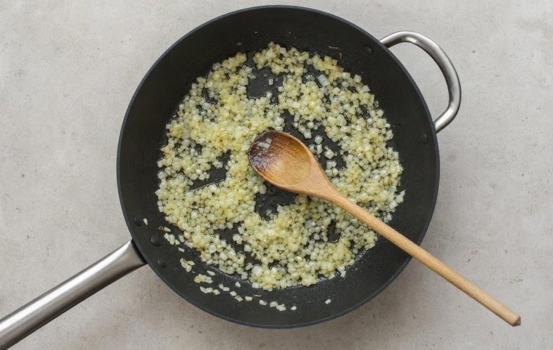 Pasta alla Carcerata, step 2: chopped onion sautéing in oil in a pan