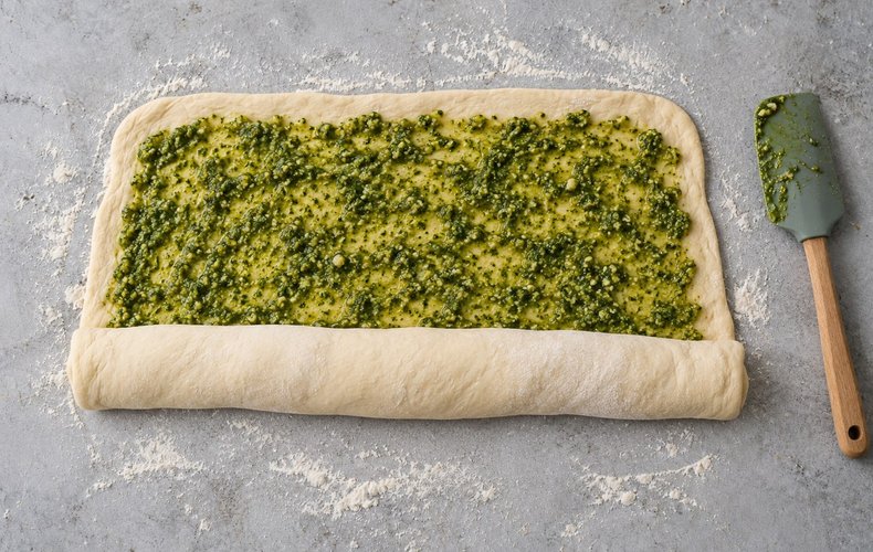 Pesto Bread Wreath, step 5: spreading the pesto and rolling up the dough