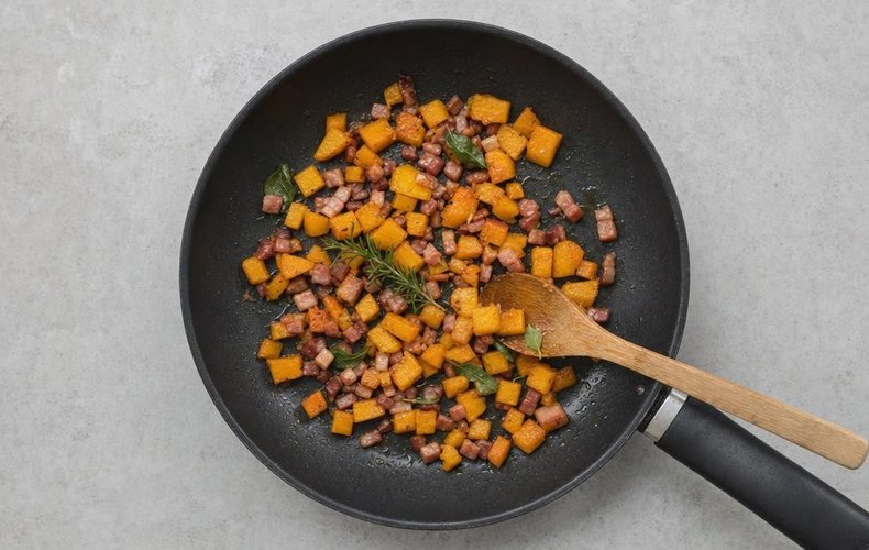 Phyllo Cups with Pumpkin, Speck and Taleggio, step 4: diced pumpkin and speck in a skillet