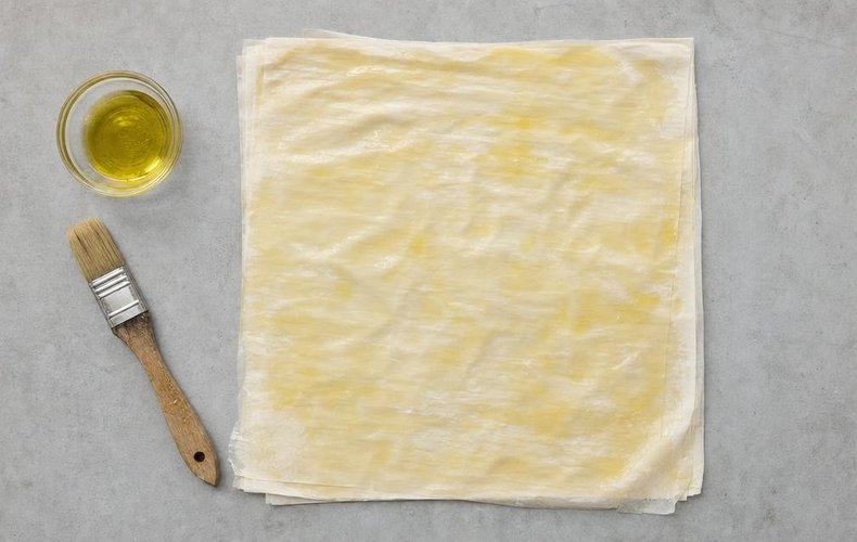 Phyllo Cups with Pumpkin, Speck and Taleggio, step 6: oiled sheets of phyllo dough stacked on the work surface