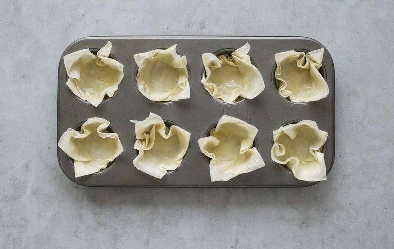 Phyllo Cups with Pumpkin, Speck and Taleggio, step 7: phyllo pieces shaped into cups in a muffin pan