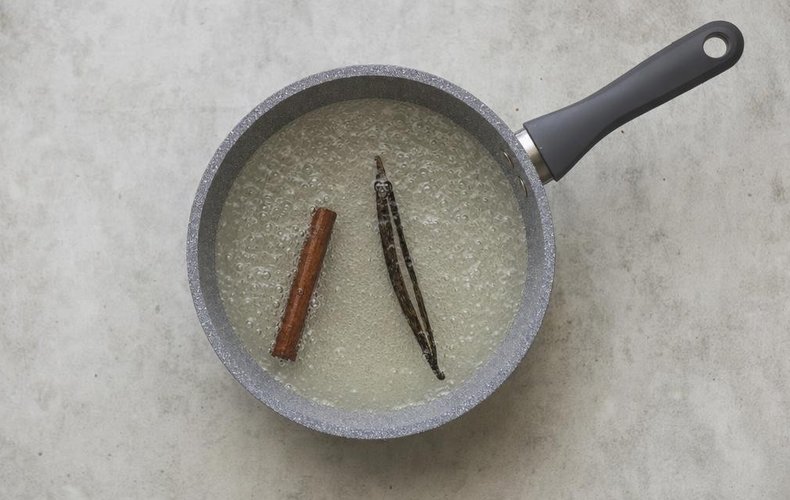 Poached Pears with Coffee Caramel Sauce, step 1: water, sugar, cinnamon sticks and vanilla bean in a pot