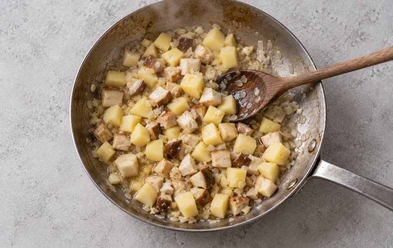 Porcini Mushroom Soup, step 3: mushrooms and potatoes cooking with onion, garlic and butter