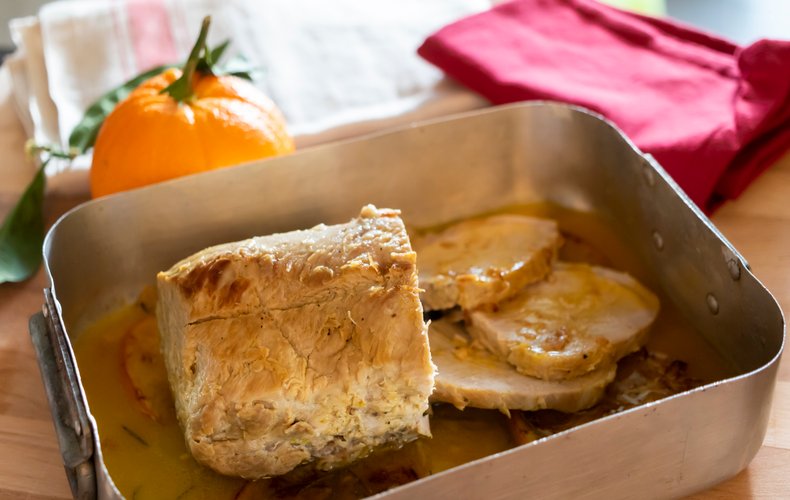 Pork loin with orange sauce in the pan