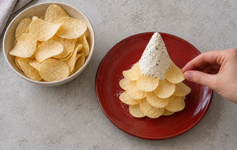 Potato Chip Christmas Tree, step 6: chips pushed into the cheese cone from the bottom up
