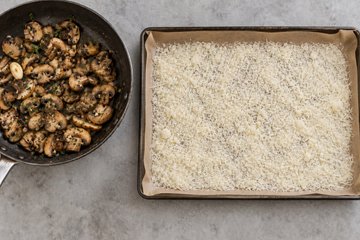 Potato, Mushroom and Scamorza Roll, step 3: grated Parmigiano spread over the parchment paper