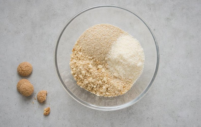 Prosecco Chicken Roll, step 1: breadcrumbs, Parmigiano and crumbled amaretti in a bowl