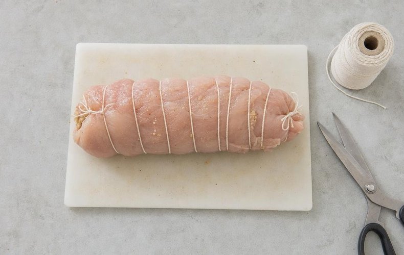 Prosecco Chicken Roll, step 4: the chicken rolled up and tied with kitchen twine