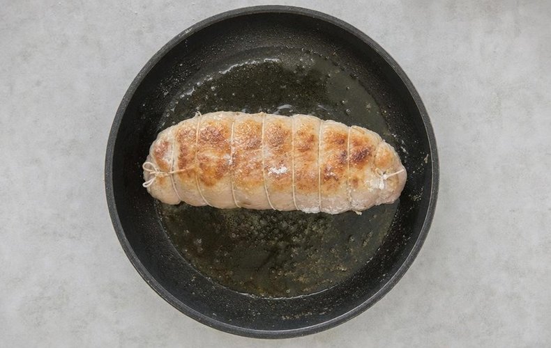 Prosecco Chicken Roll, step 5: the floured roll browning in a pan