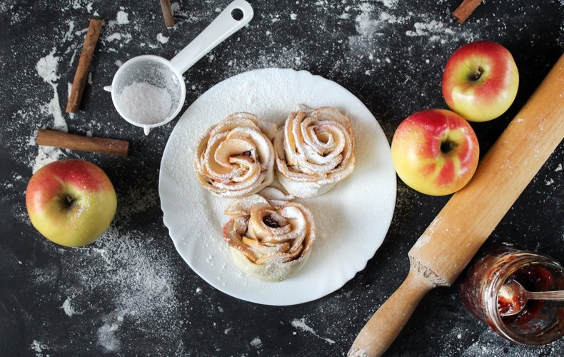 Puff pastry apple roses dusted with powdered sugar