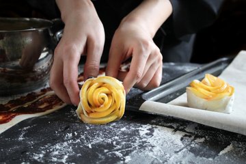 Rolling a puff pastry strip into a rose