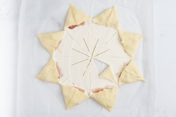 Folding the points outward over the ricotta