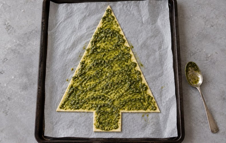 Puff Pastry Christmas Tree, step 2: pesto spread over the pastry tree