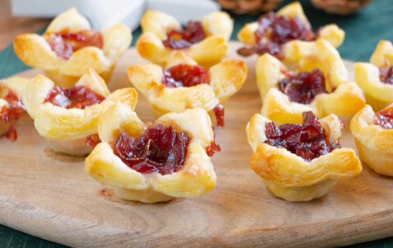 Puff pastry cups filled with brie and caramelized red onions
