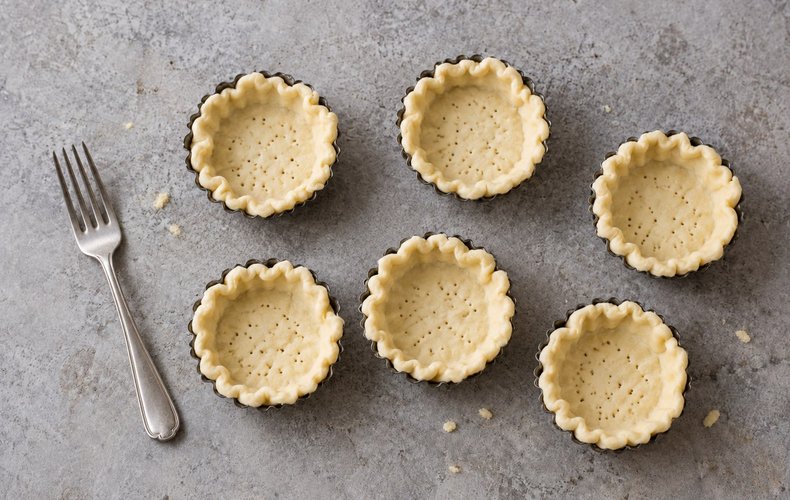 Puff Pastry Cups with Smoked Salmon Roses, step 2: puff pastry circles pressed into individual tart molds
