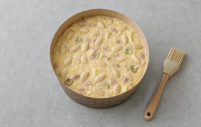 Panettone brushed with egg white and topped with almonds