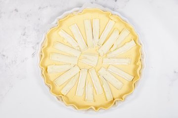 Baked savory pie with melted Brie