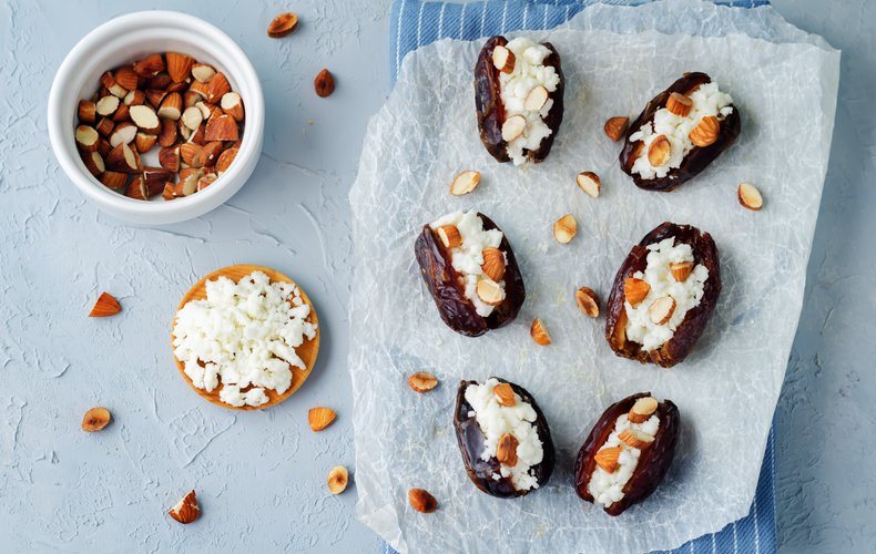 Dates stuffed with ricotta and topped with chopped nuts