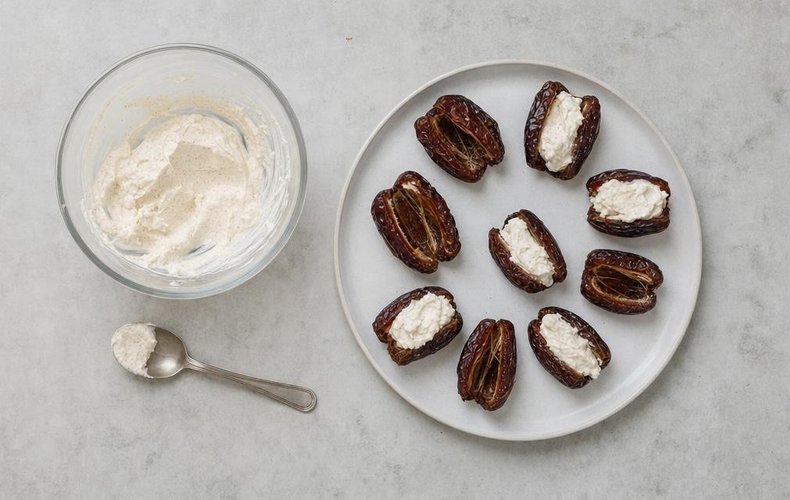 Dates filled with ricotta cream on a serving plate