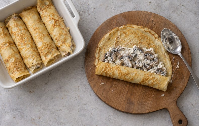 Ricotta and Mushroom Crepes, step 5: filled crepes arranged in a baking dish