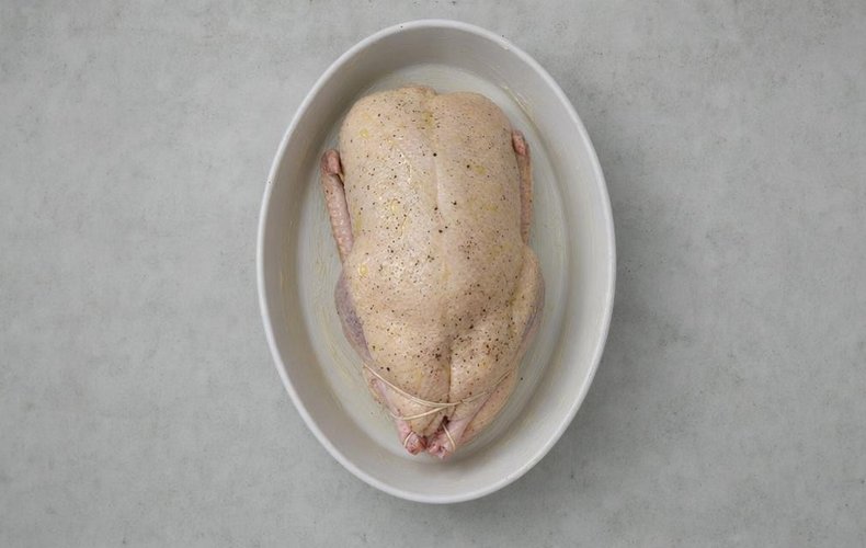 Roast Stuffed Duck, step 3: duck browning in a buttered baking dish